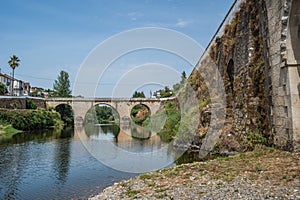 Ancient stone bridge and medieval bridge of Coja reflected in the river Alva, Arganil PORTUGAL photo