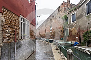 Wall of the Arsenal, boats on the Venice Canal, Italy. May 2023