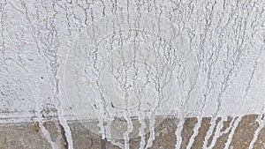 Wall background. White paint streaks on grey cement wall surface