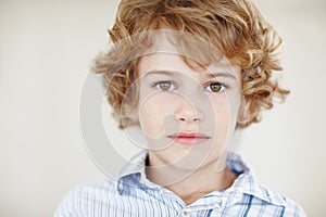 Wall background, young and portrait of child in home with serious expression, confidence and attitude. Fashion, style