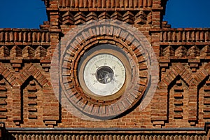 Wall barometer on top of an old brick building called circle of contributors