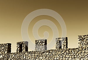 Wall with battlements, space for text, sepia hue