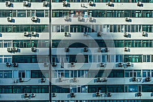 Wall of a block of flats, numerous air conditioners mounted outside the flat