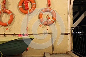 The wall of the boat station with lifebuoys at the sea pier