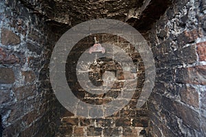 Wall brick after fire, black and charred in soot