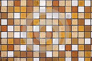 Wall of brown, beige and ocre mosaic tiles photo