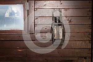 Wall of brown old boards with an old kerosene lantern