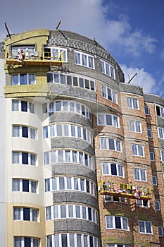 On the wall of the building are hung winches for exterior decoration. The buildings under construction are visible.