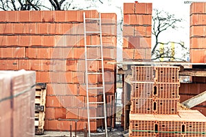 Wall building with professional bricks, construction site of new house