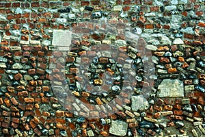 A wall built of different stones and bricks