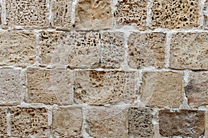 Wall built of rough weathered sandstone blocks