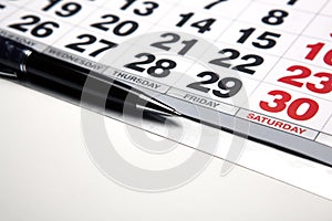 Wall calendar with pen closeup