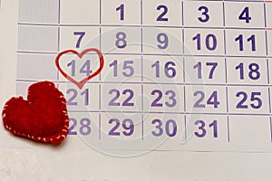 Wall calendar sheet with date February 14, Valentine`s Day. Marked with red heart