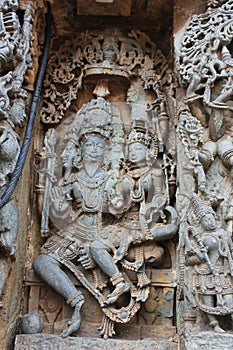 Hoysaleshwara Temple wall carving of Lord Brahma the creator with his wife Goddess Saraswathi