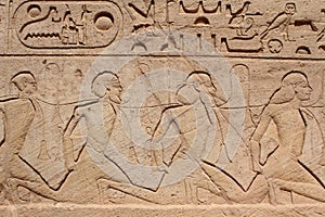 Wall carving showing war prisoners in Abou simbel temple in Aswan