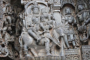 Hoysaleswara Temple wall carving of Uma Maheswara lord shiva and parvati photo
