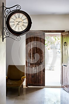 Wall clock armchair and and old rustic door