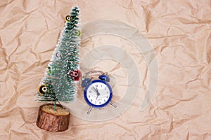 Wall clock in Christmas and New Year decorations are wrapped with fir branches and Christmas decorations. On the clock five