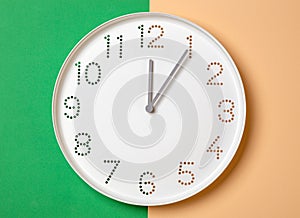 wall clock on a colored background show one o\'clock