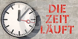 Wall clock on concrete wall with German lettering: Die Zeit lÃ¤uft