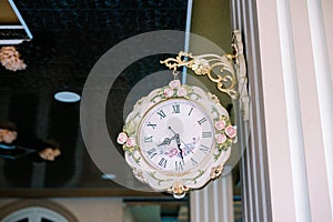 A wall clock hung on a wall, its hands ticking away the moments,