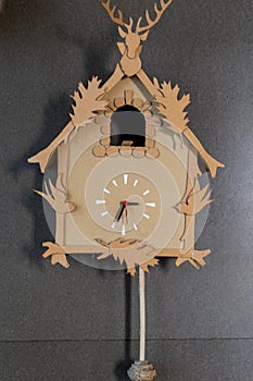 wall clock with pendulum and manual ornamentation built in cardboard