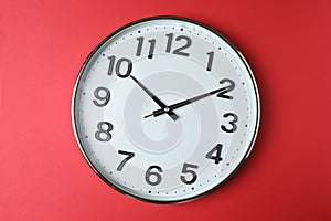 wall clock on a red