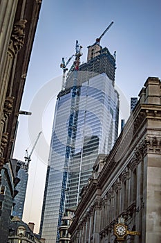 The wall clock at royal exchange london and under construction building