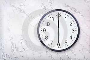 Wall clock show six o`clock on white marble texture. Office clock show 6pm or 6am