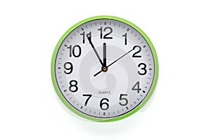 Wall clock on white background. Clipping path included. Five minutes to twelve