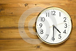 Wall clock on the wooden wall