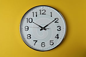wall clock on a yellow