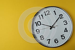 wall clock on a yellow