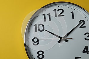 wall clock on a yellow