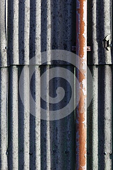 Wall of corrugated asbestos material