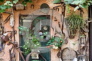 wall of a countryhouse full of tools and instrument for gardening and farming