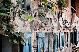 wall of a countryhouse full of tools and instrument for gardening and farming