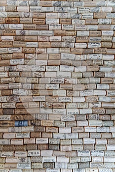 Wall covered with corks from various wineries