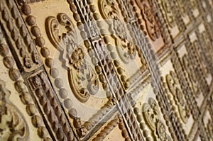 Wall covered by decorative ceramic tiles with ornaments