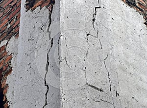 a wall with a cracked and cracked concrete wall