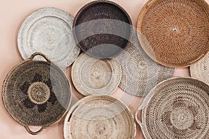 Wall decorated with different wicker handmade tray photo