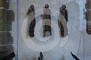 Wall decorated by old historical little statues in church
