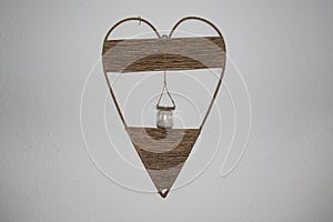 Wall decoration of a heart made of straw with sand from the beach