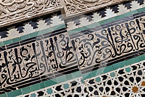 Wall detail with carved plaster and koranic verse calligraphy, Bou Inania Madrasa in Fes photo