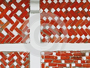Wall detail with red bricks and white beams at a Dutch countryside house