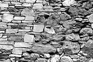Wall of different black and white stones photo