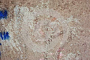 Wall with dirty plaster and blue spots, grunge texture