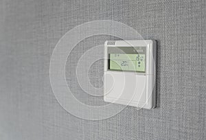 Wall display shows air temperature inside the apartment room. Smart home automation. Showing household consumptions