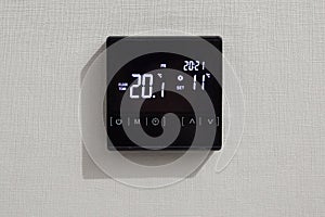 Wall display shows air temperature inside the room. Smart black panel with screen for home or office