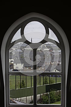 Wall Dividing Belfast Neighborhoods from Catholic Church Window